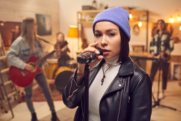 Young female with microphone singing in front of camera
