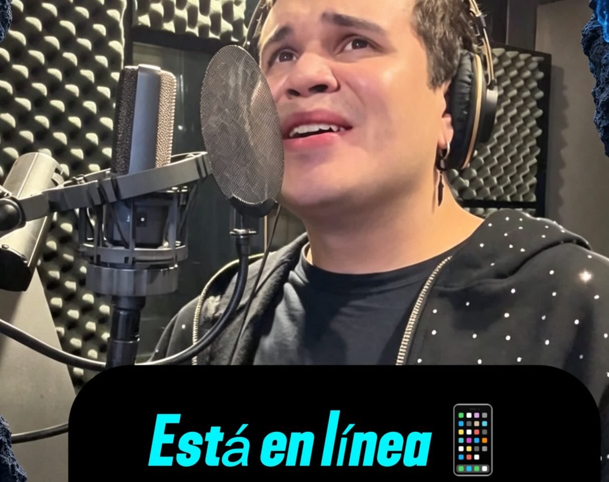 Alexis Guadner singing into a gold microphone in a vocal booth