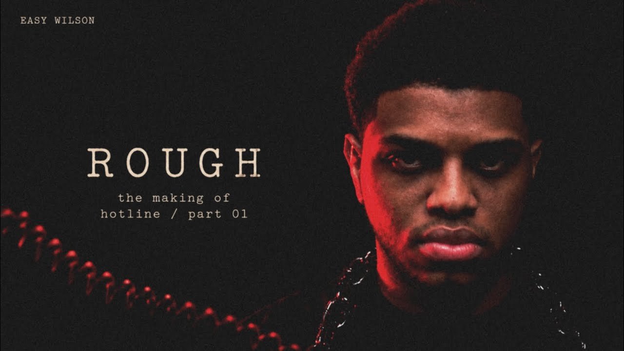 Easy Wilson lit in red with chains for the making of his single Rough
