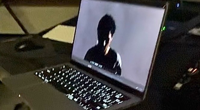 A laptop screen in a dark room showing kateo's My Love video edit