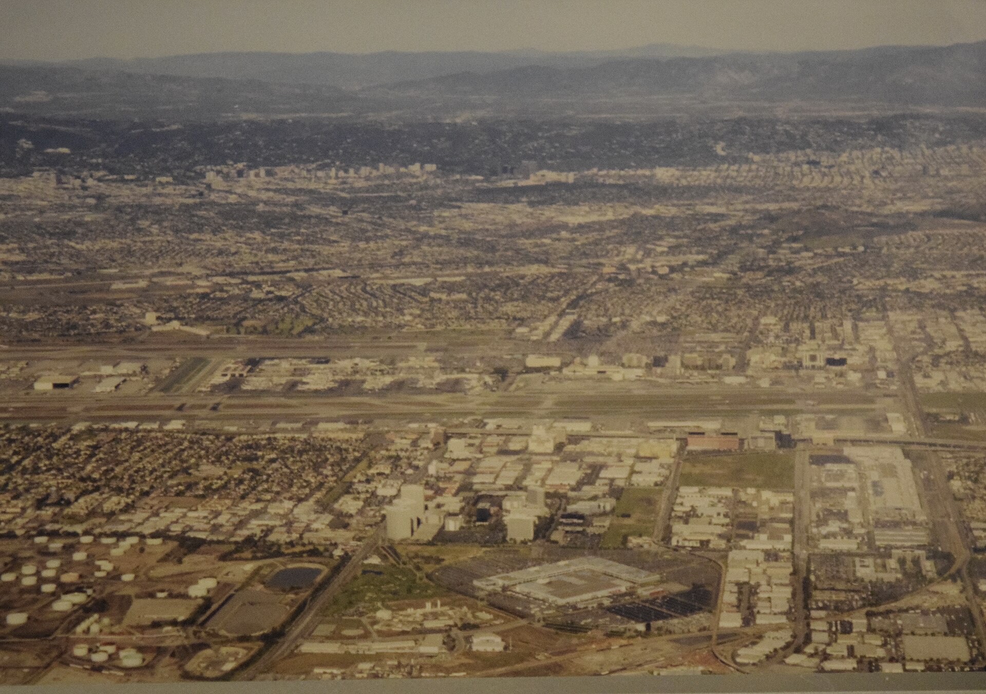 Aerial photo of the Los Angeles basin in the 1990s, flat city grid stretching toward the hills