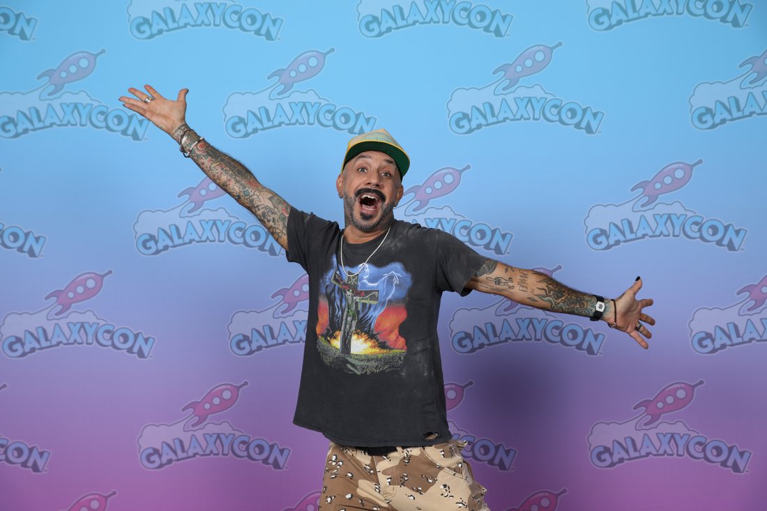 AJ McLean of the Backstreet Boys posing with arms outstretched in 2023
