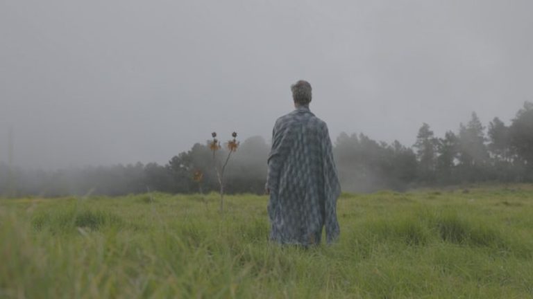 Bryce Lamar standing in a foggy field at Valle Nuevo in the Heaven music video