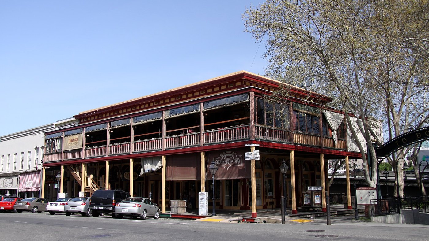 A two-story brick building with a wooden balcony in the Old Sacramento Historic District
