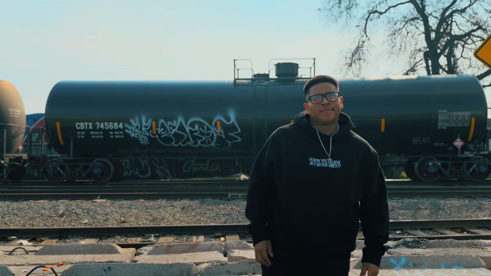 EGR standing beside a freight train in the Big Brother music video