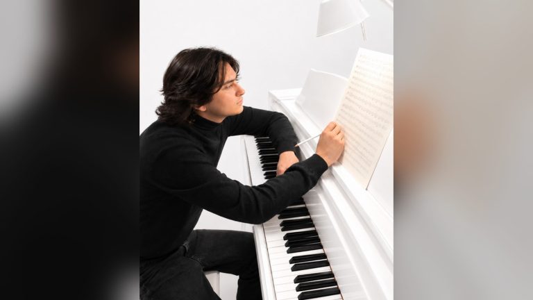 Ettore Bandel, Italian pianist and composer, at a white piano