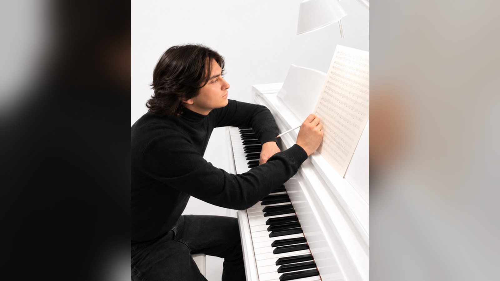 Ettore Bandel, Italian pianist and composer, at a white piano