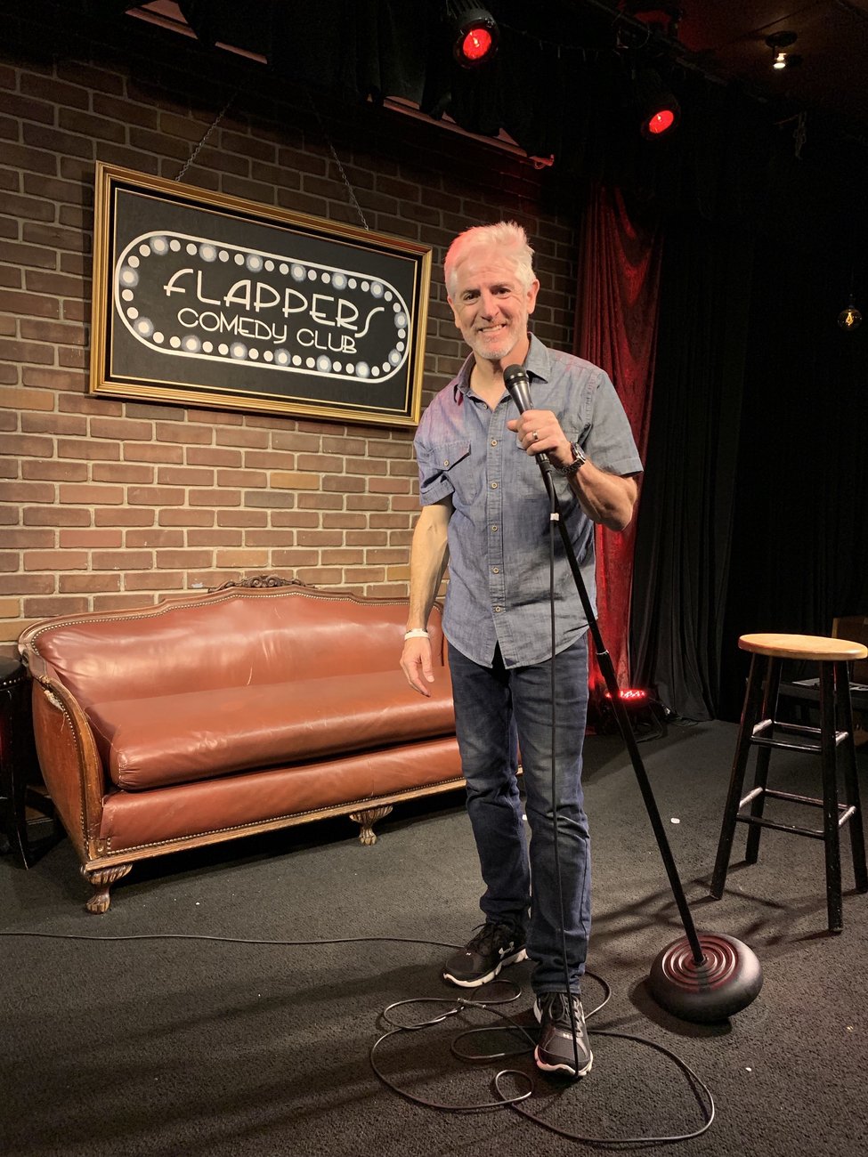 Comedian Carlos Alazraqui on stage at Flappers Comedy Club in Burbank