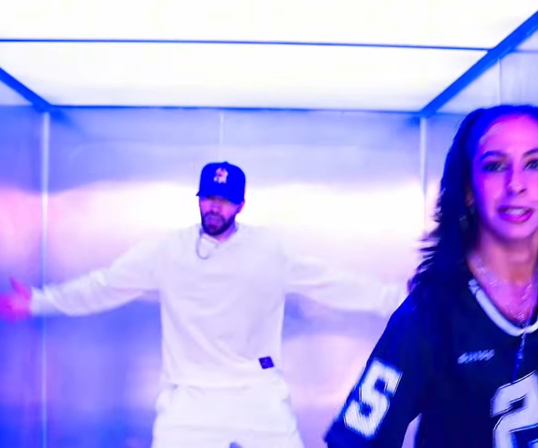 Gawne laughing behind bars in the TV Off remix video