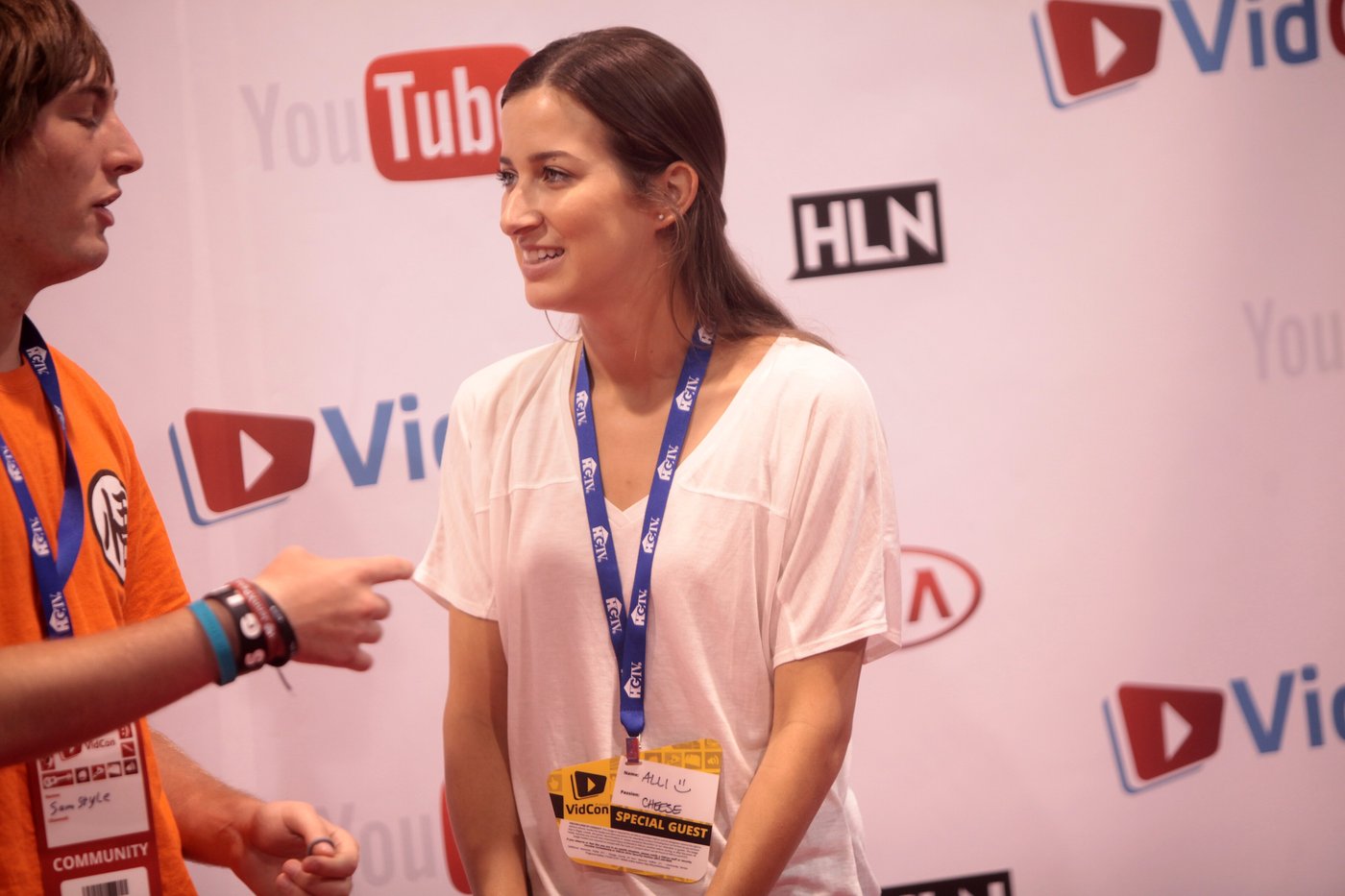 Alli Speed being interviewed in front of a VidCon backdrop