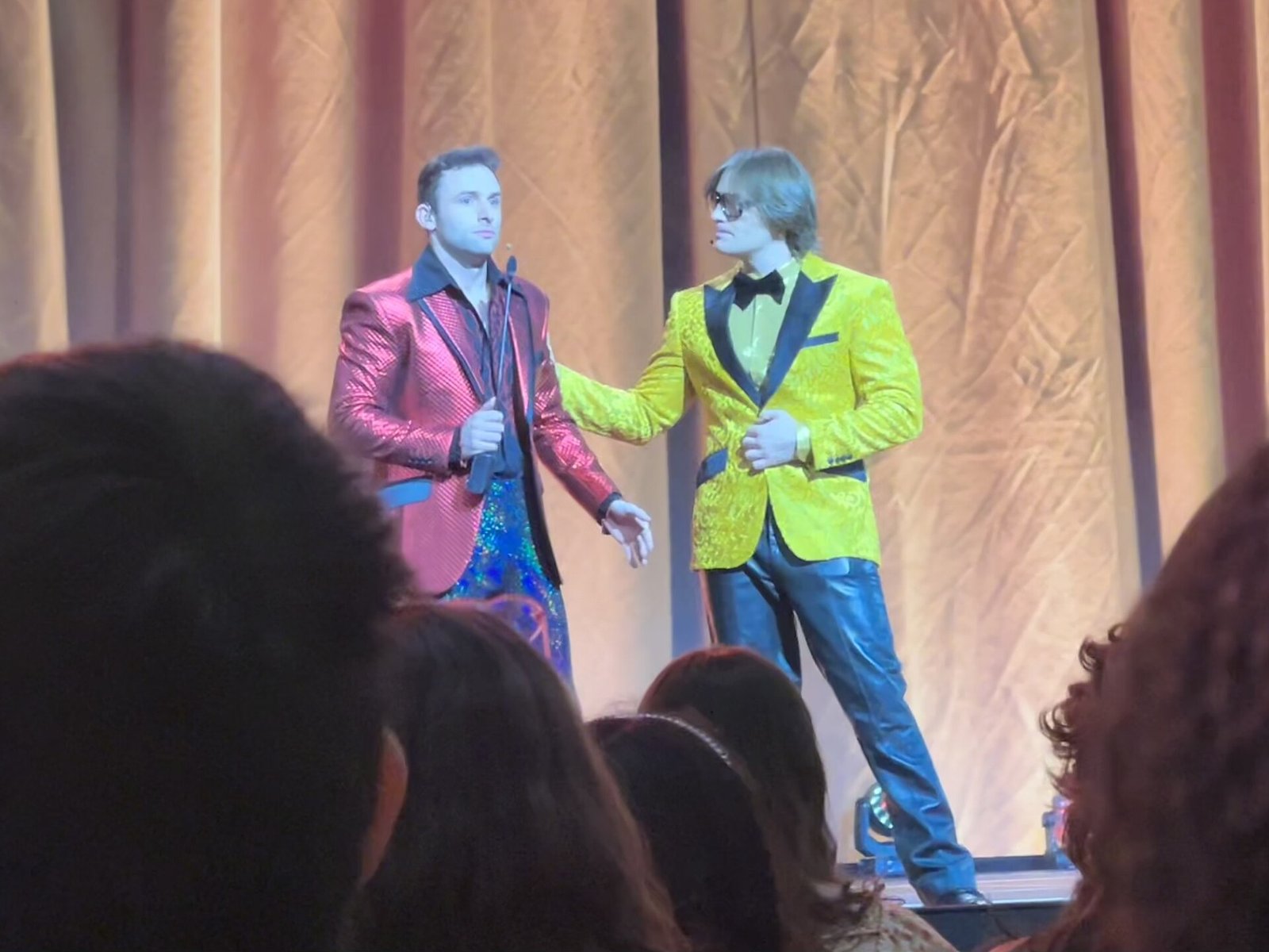 Two performers on stage at TwitchCon 2023 during the Name Your Price show