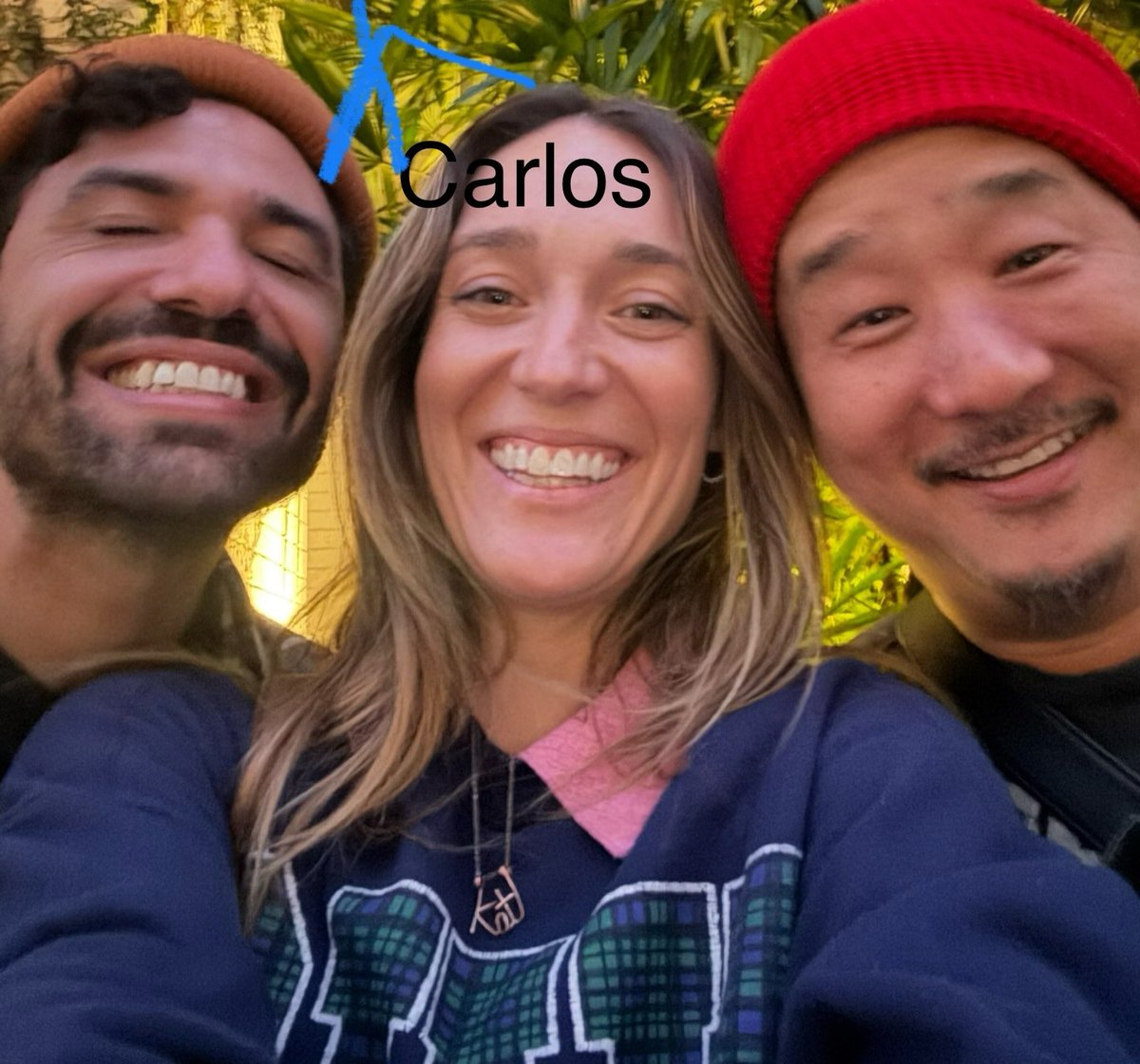 Kat Bird smiling in a selfie with comedians Bobby Lee and Carlos Herrera while on tour
