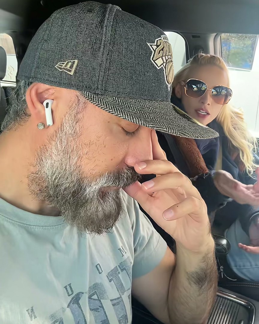 Sid Griego pinching the bridge of his nose in the driver’s seat while Kiley explains Apple Pay