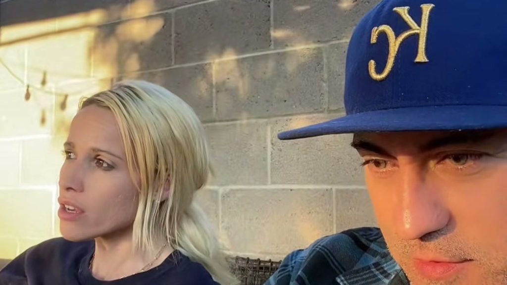 Kiley and Sid Griego sitting together in their backyard during their cordless water hose TikTok