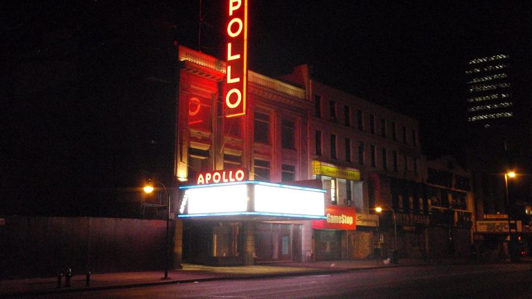 The Apollo Theater marquee lit up at night on 125th Street in Harlem