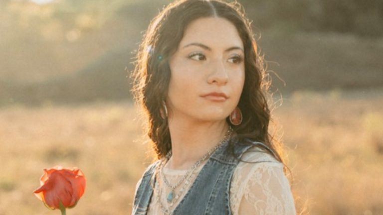 Lilly Amaris, Christian singer-songwriter, holding a red rose in a golden field