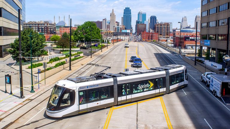 A KC Streetcar leaving Union Station with the downtown Kansas City skyline behind it