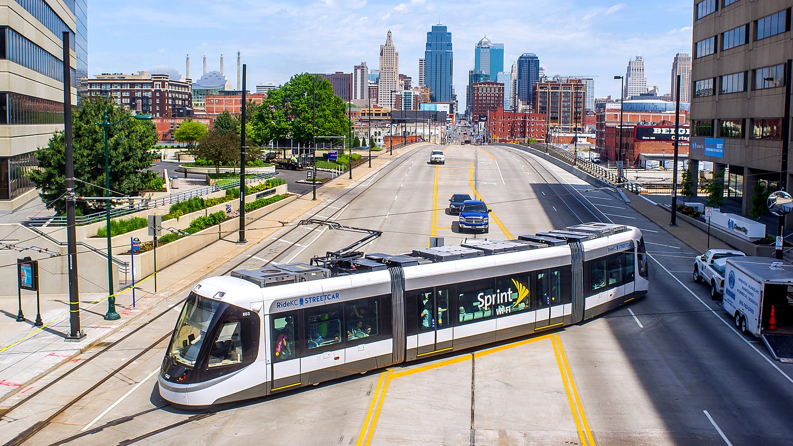 A KC Streetcar leaving Union Station with the downtown Kansas City skyline behind it