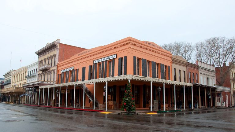 Historic storefronts with covered wooden sidewalks in the Old Sacramento Historic District on a rainy day