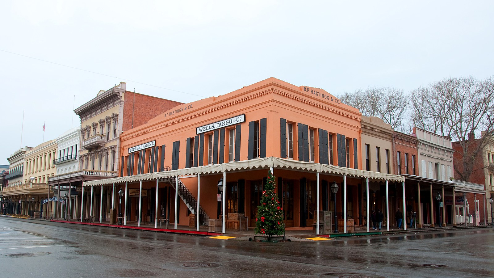 Historic storefronts with covered wooden sidewalks in the Old Sacramento Historic District on a rainy day