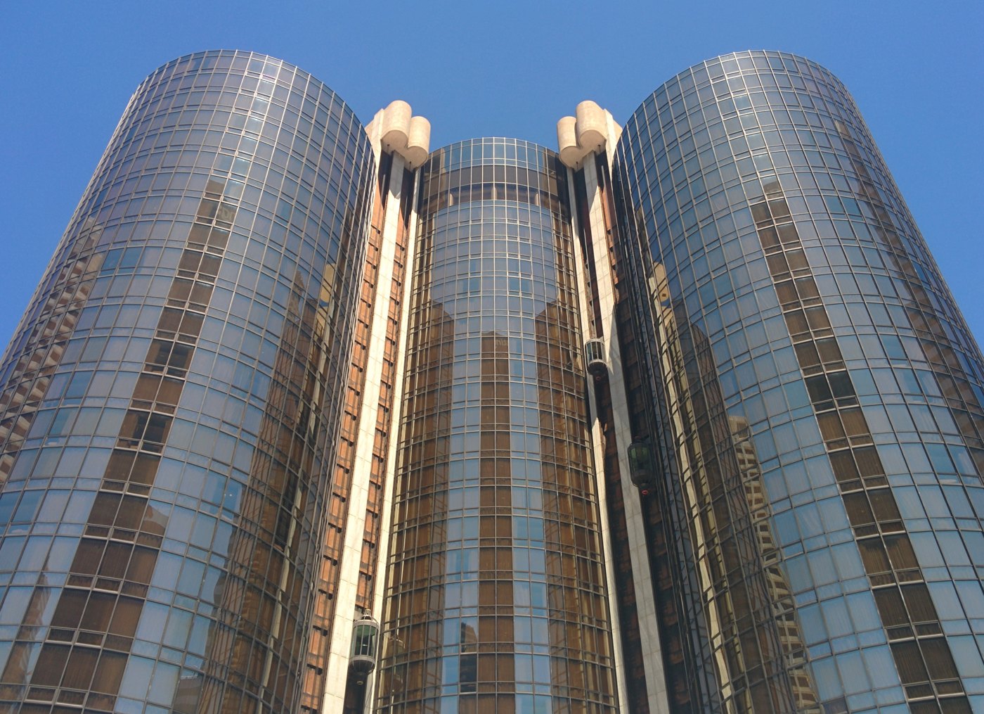 The cylindrical glass towers of the Westin Bonaventure hotel against a blue sky in Downtown Los Angeles