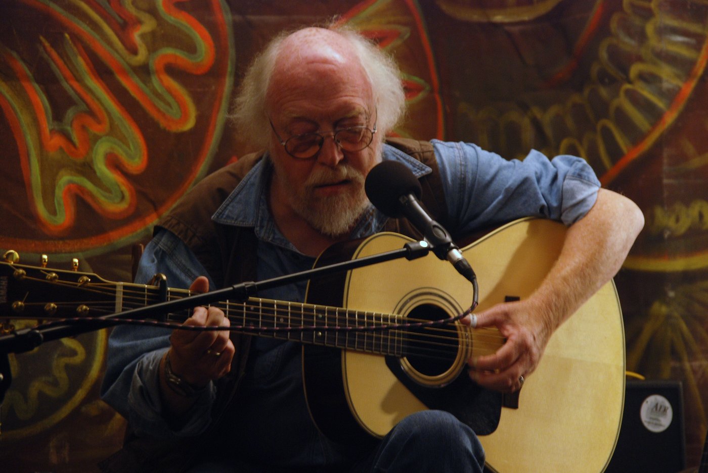 John Kirkbride singing and playing acoustic guitar