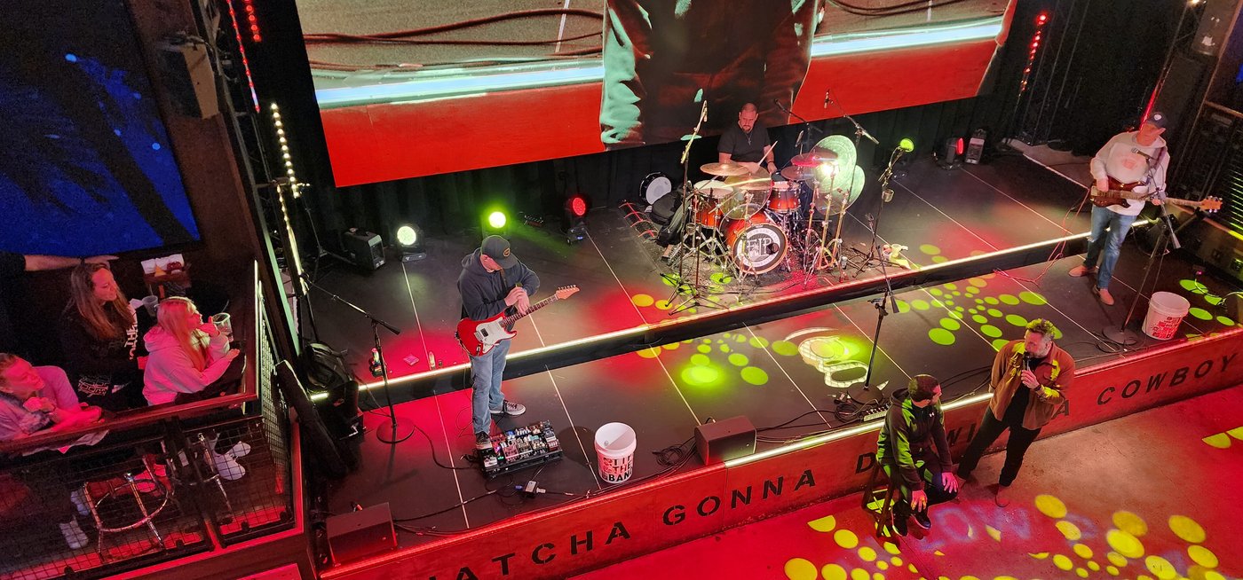 A country band playing on stage inside a Nashville honky-tonk