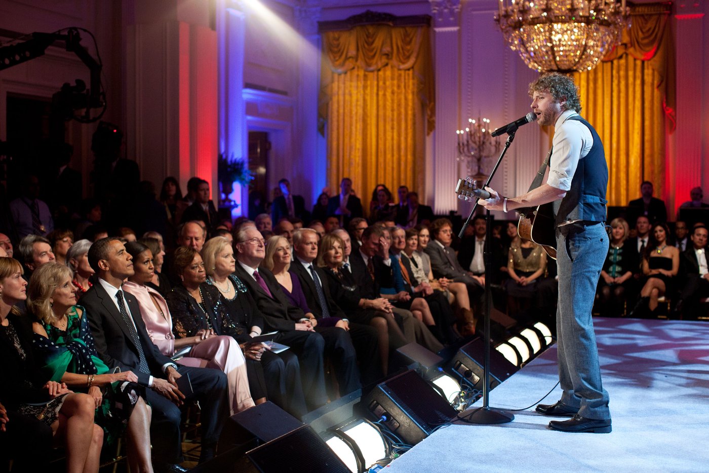 Dierks Bentley singing with an acoustic guitar in the East Room of the White House